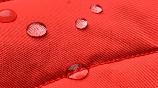 red waterproof fabric with some water drops on it