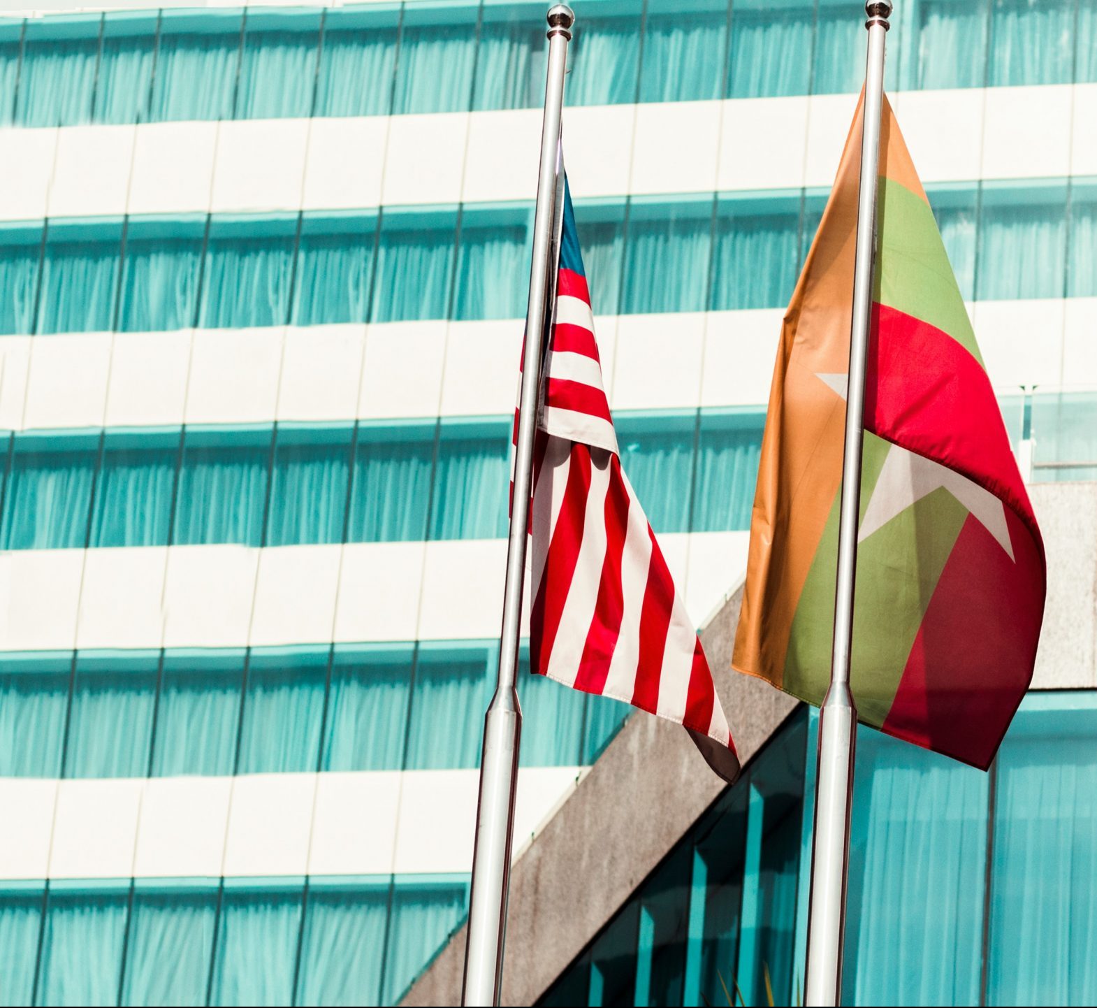 US, Myanmar and several flags standing together