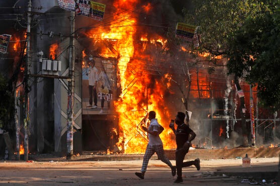 houses in fire in a riot in Bangladesh